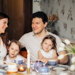A warm family gathering celebrating a traditional Russian holiday indoors with festive food and decor.