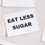 Minimalist photograph of motivational cards with healthy lifestyle messages on a white background.